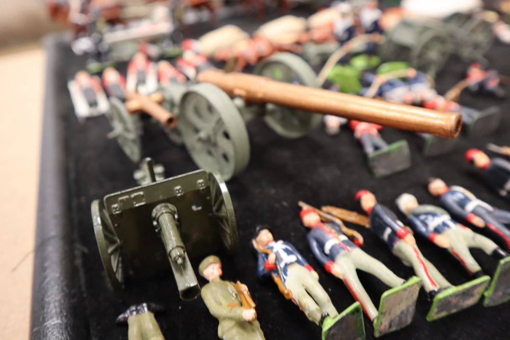 A collection of painted Britains and Holocast lead soldiers, artillery pieces, including some rare dated including Scots Guards chargin